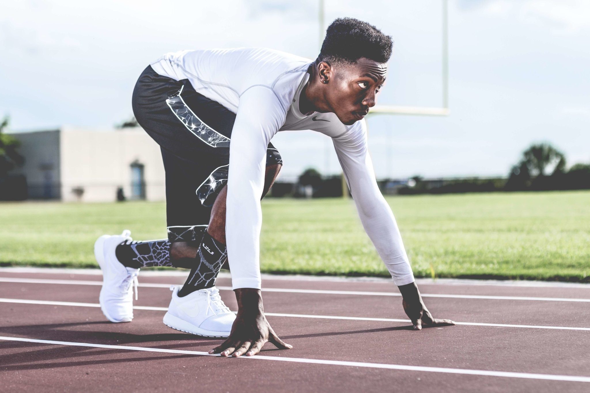 Athlete preparing to sprint from starting blocks